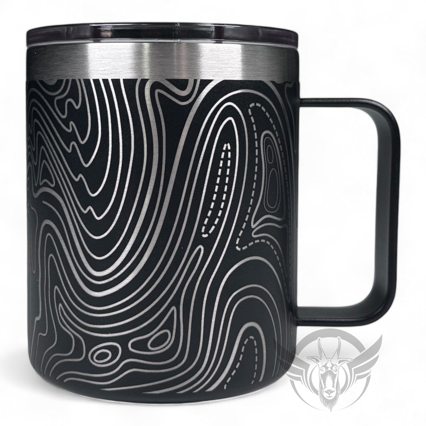 A black travel mug with a handle features a wrap-around line topography design. The handle is to the right.