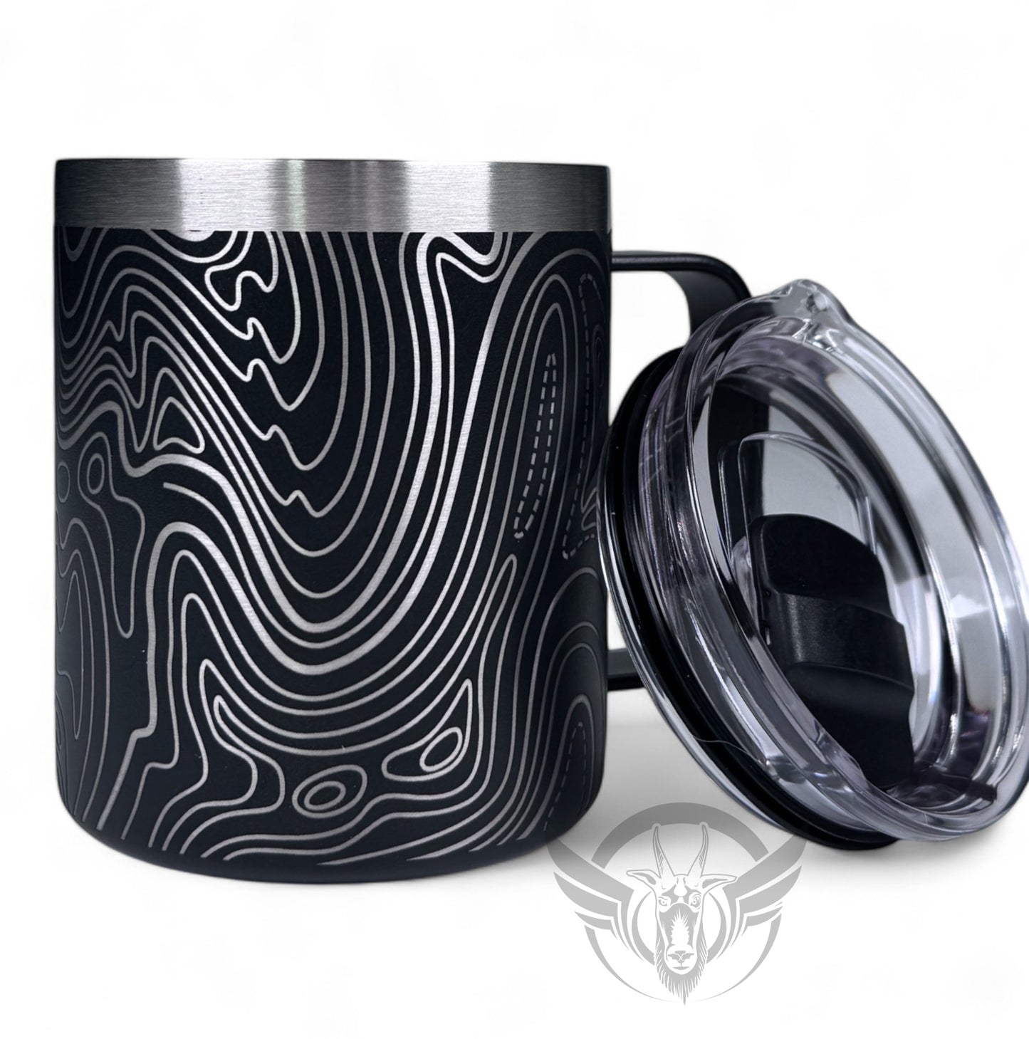 A black travel mug with a handle features a wrap-around line topography design. The handle is to the right, with lid leaning against the mug.