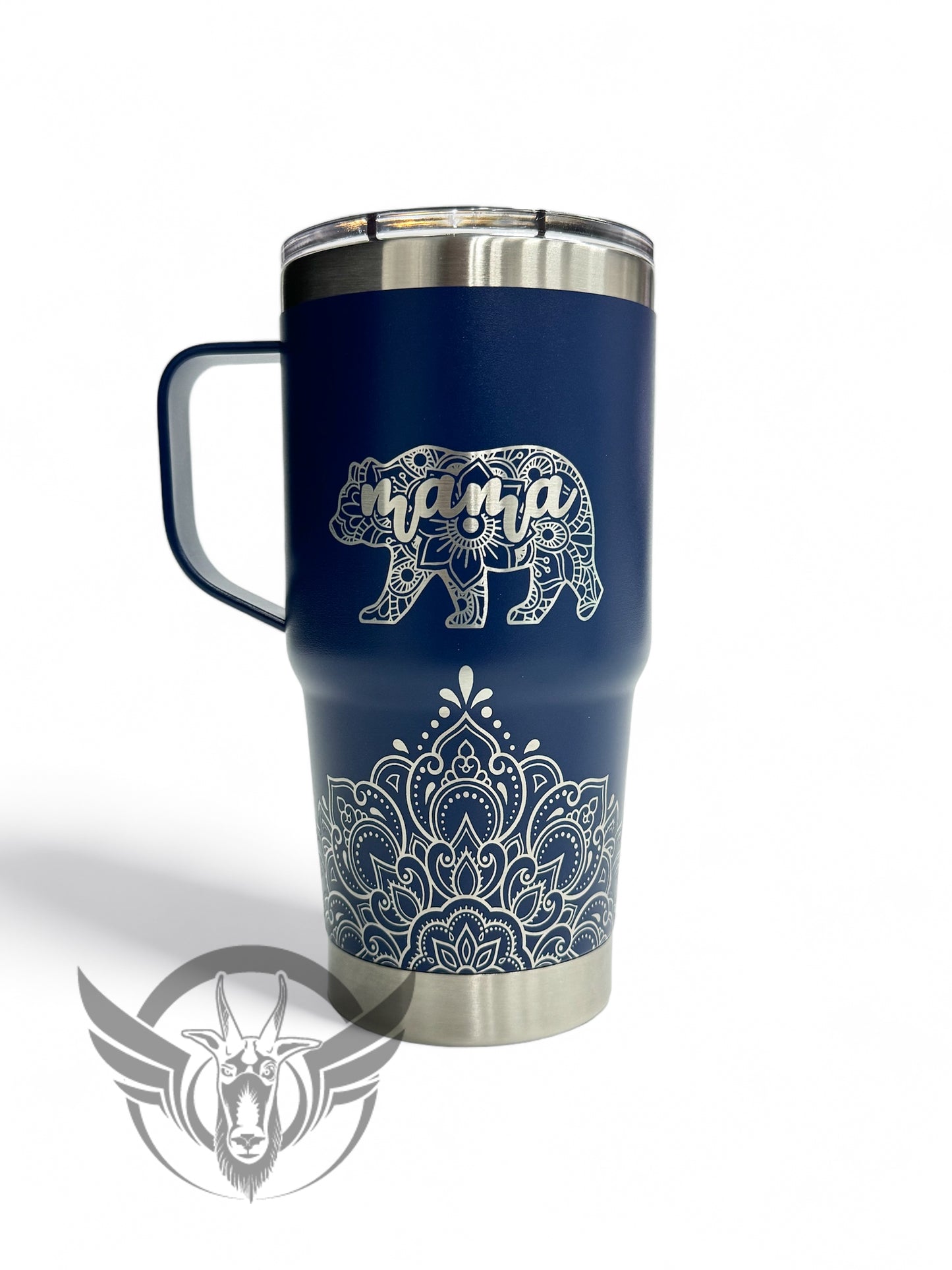 A navy blue travel mug with a lid and handle show off an intricate mandala design along the bottom front. Above the design is a bear shaped image made with a mandala design and includes the word "mama" within it.